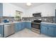 Newly renovated kitchen, featuring blue cabinets and quartz countertops at 1554 Middle Ridge Dr, Willow Springs, NC 27592