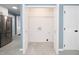 Bright laundry room with built-in shelving and tile floor at 1554 Middle Ridge Dr, Willow Springs, NC 27592