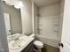 Well-lit bathroom with a shower-tub combo, tile floors, and single sink vanity create a functional space at 162 Vega Loop, Sanford, NC 27330