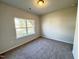 Bright bedroom with plush carpet, a large window, and plenty of natural light at 162 Vega Loop, Sanford, NC 27330