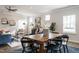Open dining area with wood table, chairs, and cozy decor, leading to a living room at 162 Vega Loop, Sanford, NC 27330