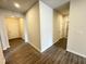 Open hallway with luxury vinyl plank flooring with access to the front door, laundry, and other rooms at 162 Vega Loop, Sanford, NC 27330