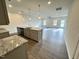 Bright, open kitchen with granite countertops, stainless steel appliances, and a central island overlooking the living area at 162 Vega Loop, Sanford, NC 27330
