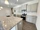 Modern kitchen with a granite island, stainless steel appliances, and plenty of cabinet space for all your culinary needs at 162 Vega Loop, Sanford, NC 27330