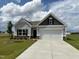 Charming single-story home with gray siding, a two-car garage, and a well-maintained lawn at 17 E Victory View Ter, Smithfield, NC 27577