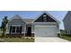 Charming single Gathering home featuring two-car garage and manicured lawn at 17 E Victory View Ter, Smithfield, NC 27577