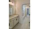 Bathroom view showcasing a sink vanity and bathtub shower combo with neutral tile flooring at 2006 Anna Lilley Dr # 72, Fuquay Varina, NC 27526