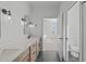 Bathroom with double vanity, quartz countertop, and view to bedroom and water closet at 2006 Anna Lilley Dr # 72, Fuquay Varina, NC 27526