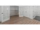 View of an open bedroom featuring wood-look flooring, and access to ensuite bathroom and closet at 2006 Anna Lilley Dr # 72, Fuquay Varina, NC 27526