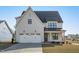 Beautiful new construction home with a spacious two-car garage, manicured lawn, and covered entry at 2006 Anna Lilley Dr # 72, Fuquay Varina, NC 27526