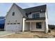 New construction two-story home with attached two-car garage, covered porch, and modern design at 2006 Anna Lilley Dr # 72, Fuquay Varina, NC 27526