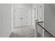 Upstairs hallway with carpeting, linen closet, and multiple access doors at 2006 Anna Lilley Dr # 72, Fuquay Varina, NC 27526