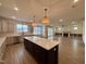 Open floor plan with modern kitchen island and stainless steel appliances and a large living space at 2006 Anna Lilley Dr # 72, Fuquay Varina, NC 27526