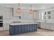 Bright kitchen features shaker cabinets, quartz countertops, a subway tile backsplash, and a large island at 2006 Anna Lilley Dr # 72, Fuquay Varina, NC 27526