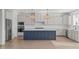 Kitchen boasts a large blue island, stainless steel appliances, and stylish pendant lighting at 2006 Anna Lilley Dr # 72, Fuquay Varina, NC 27526