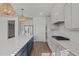 Modern kitchen boasts white cabinets, stainless steel appliances, a large island with seating and pendant lighting at 2006 Anna Lilley Dr # 72, Fuquay Varina, NC 27526