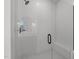 Modern glass shower with white tile, black hardware, and a built-in bench at 2006 Anna Lilley Dr # 72, Fuquay Varina, NC 27526