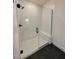 A frameless glass shower features white tile, a built-in bench, and black hardware at 2006 Anna Lilley Dr # 72, Fuquay Varina, NC 27526