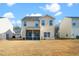 Two-story house with screened porch and grassy backyard at 2019 Tennessee Rd, Durham, NC 27704
