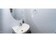 Small half bathroom with a sink and oval mirror at 2019 Tennessee Rd, Durham, NC 27704