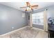 Cozy bedroom with gray walls, window seating, and a ceiling fan at 2019 Tennessee Rd, Durham, NC 27704