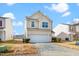 Tan two-story house with a white garage door at 2019 Tennessee Rd, Durham, NC 27704