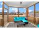 Screened porch with teal furniture and backyard view at 2019 Tennessee Rd, Durham, NC 27704