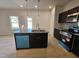 Modern kitchen with island, granite countertops, and teal appliances at 216 Vili Dr, Broadway, NC 27505