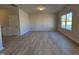 Spacious living room showcasing neutral tones, a large window, and hardwood floors at 216 Vili Dr, Broadway, NC 27505