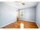 Bright bedroom with gleaming hardwood floors, a window, and a ceiling fan at 2205 Lacy St, Burlington, NC 27215