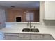 White cabinets, granite countertops, and stainless steel sink in kitchen at 2232 Ventana Ln, Raleigh, NC 27604