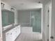 Spacious bathroom featuring a double vanity, large mirror, and a walk-in shower at 310 N Maple Walk # 236, Garner, NC 27529