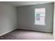 A well-lit empty bedroom featuring a large window allowing plenty of sunlight at 310 N Maple Walk # 236, Garner, NC 27529