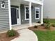 Inviting front entryway with a stylish door, white columns, and lush landscaping at 310 N Maple Walk # 236, Garner, NC 27529
