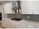 Close-up of kitchen with stainless steel hood and white cabinets at 310 N Maple Walk # 236, Garner, NC 27529
