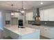 Gourmet kitchen with a large island, stainless steel appliances, and pendant lighting at 310 N Maple Walk # 236, Garner, NC 27529