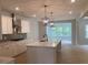 Spacious kitchen featuring a large island, stainless steel appliances, and modern lighting at 310 N Maple Walk # 236, Garner, NC 27529