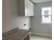 Bright laundry room with modern cabinetry and ample counter space at 310 N Maple Walk # 236, Garner, NC 27529