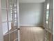Versatile living room showcasing lots of natural light, hardwood floors, and double doors at 310 N Maple Walk # 236, Garner, NC 27529