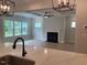 Bright living room with large windows, ceiling fan, fireplace, and an open floor plan at 310 N Maple Walk # 236, Garner, NC 27529