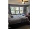 Bedroom showcases a large window, a ceiling fan, and a neutral color scheme at 4904 Arbor Chase Dr, Raleigh, NC 27616