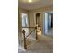 Hallway featuring carpeted floors, neutral walls, and open doorways to various rooms, including a bathroom at 4904 Arbor Chase Dr, Raleigh, NC 27616