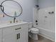 Updated bathroom with white vanity and bathtub at 5909 Clarks Fork Dr, Raleigh, NC 27616