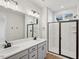 Modern bathroom with double vanities, a large shower, and gray cabinets at 600 Hillfarm Dr, Wake Forest, NC 27587