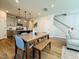 Open-concept dining area featuring modern lighting, stylish seating, and easy access to the kitchen at 600 Hillfarm Dr, Wake Forest, NC 27587