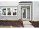 Modern front door with a covered entryway and landscaping at 600 Hillfarm Dr, Wake Forest, NC 27587
