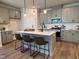 Well-designed kitchen featuring a large island, gray cabinets, and sleek stainless steel appliances at 600 Hillfarm Dr, Wake Forest, NC 27587