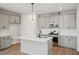 Modern kitchen with gray cabinets, quartz countertops, and stainless steel appliances at 600 Hillfarm Dr, Wake Forest, NC 27587