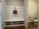 Convenient mudroom with built-in bench, storage cubbies, and easy access to a half bath at 600 Hillfarm Dr, Wake Forest, NC 27587