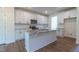 Bright kitchen with white cabinets, granite countertops, and an island at 6100 Sunset Lake Road Rd, Fuquay Varina, NC 27526